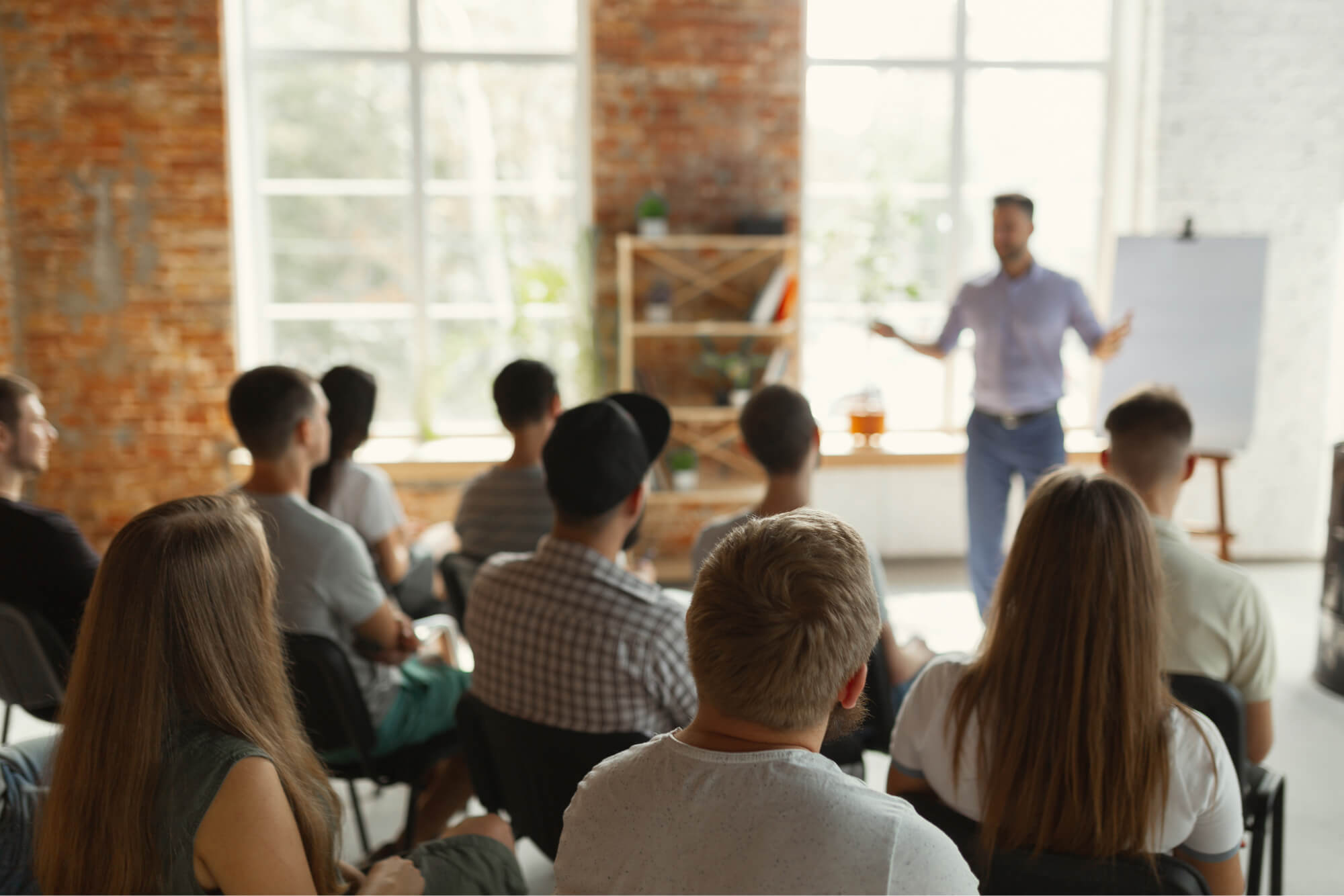 Photo of a presenter speaking in front of a group of people