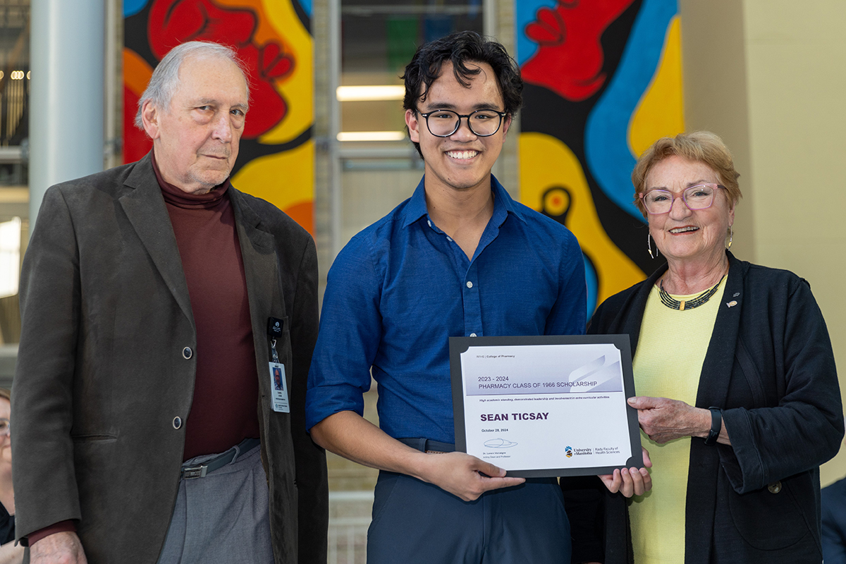 Pharmacy award recipient Sean Ticsay with Class of 1966 alumni Dan Sitar and Marian Kremer