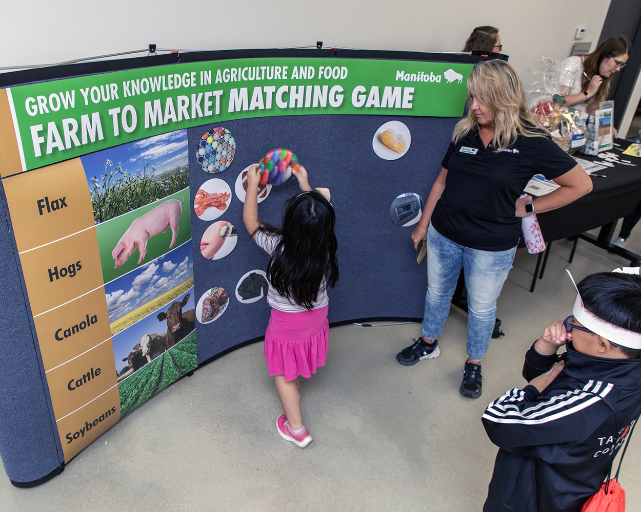 Children interact with an agriculture theme educational display