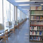 Rows of study carrels and bookshelf at Elizabeth Dafoe Library