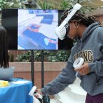 A student wearing a VR headset tries navigating a health-care scenario at the RadyVerse launch.