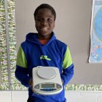 Student holding a piece of lab equipment.