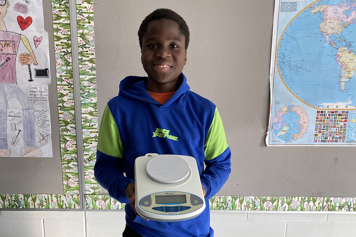 Student holding a piece of lab equipment.