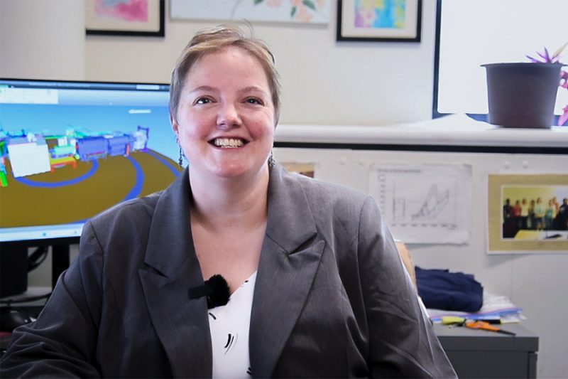 Dr. Juliette Mammei smiling at the camera sitting in her office.