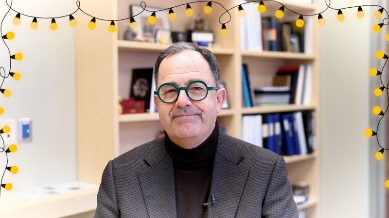 Dr. Peter Nickerson in his office smiling with graphic of lights around the frame