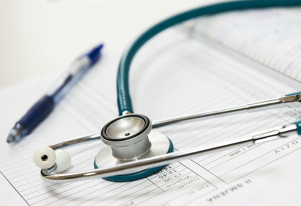 Stethoscope and a pen on a patient chart.