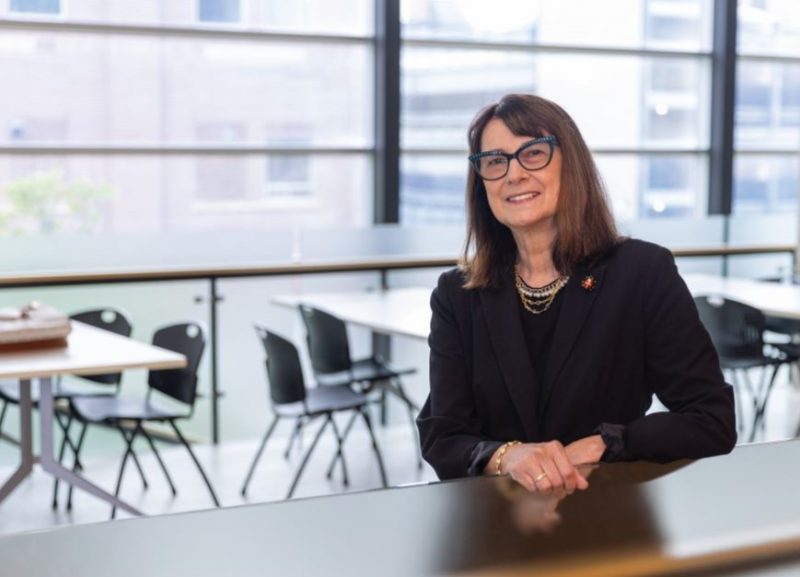 Dr. Silvia Alessi-Severini stands at a counter in a student lounge.