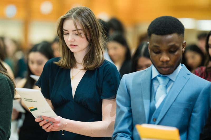 Graduands Sophie Harms and Tolulope Akinloye recite the UM Bachelor of Nursing page with their graduating class.