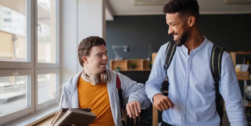 Teacher and student smiling and walking