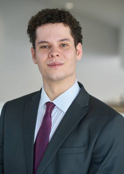 Portrait of a young man wearing a suit and tie.