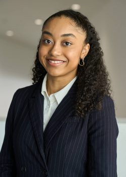 Portrait of a young woman in a suit.