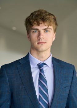 Portrait of a young man wearing a suit and tie.