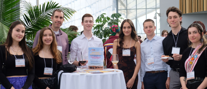 A group of students standing around a cocktail table at Bison Spirit and ICE gathering event.