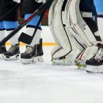 Hockey players skates and sticks on ice. Photo by Tony Schnagl