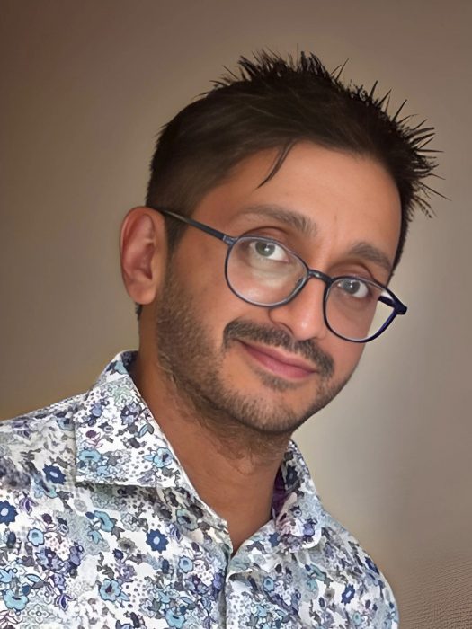 Dr. Ashley Vergis' headshot against a brown background.