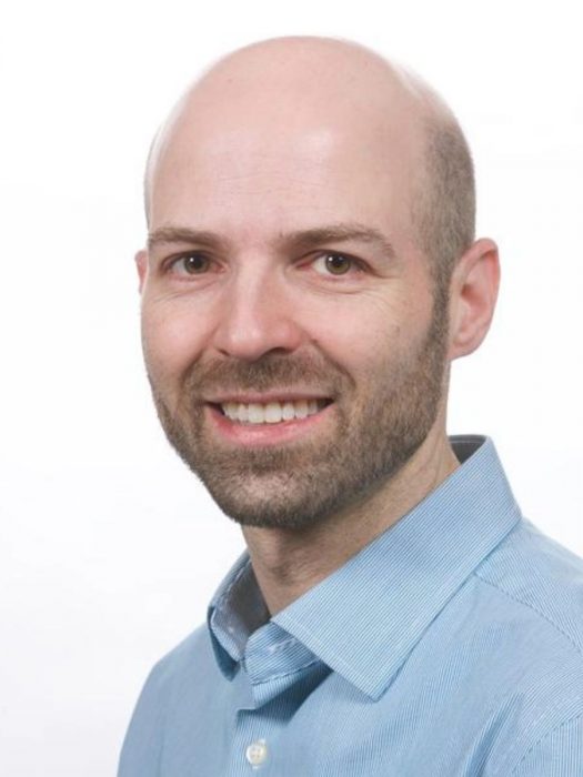 Dr. Lawrence Gillman's headshot against a white background.