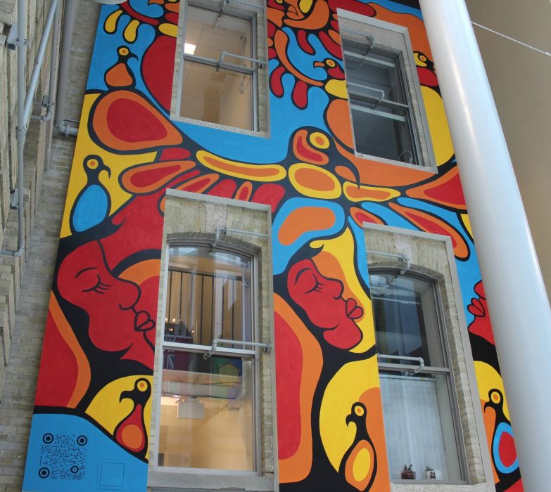 Tall and colourful mural featuring thunderbird at the center