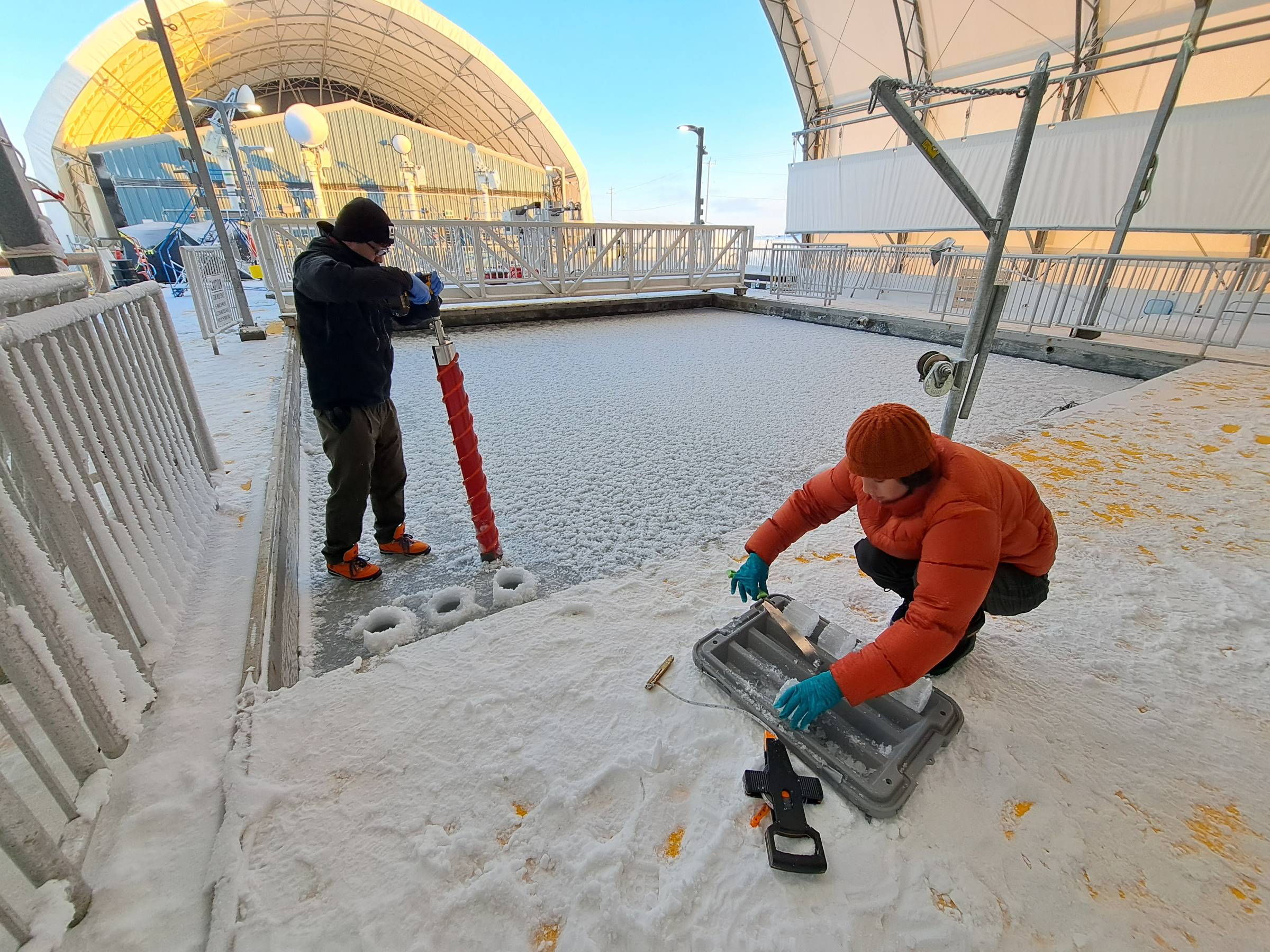 A pair of researchers are conducting tests on ice and water at the Churchill Marine Observatory.