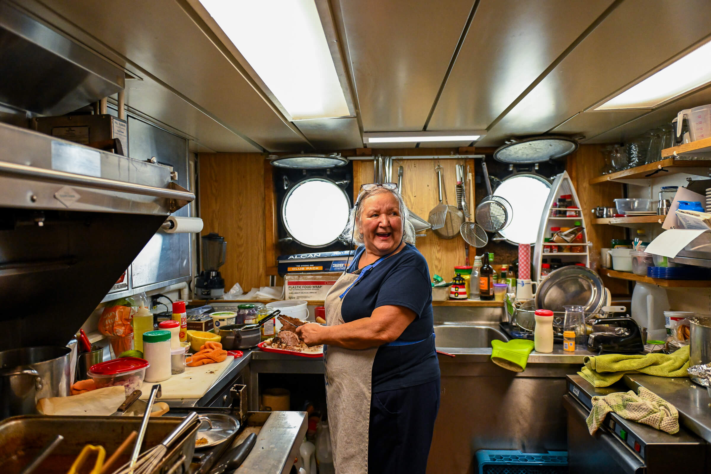 Rhonda Thornsteinson, a long-time cook aboard the Namao, makes brisket for lunch