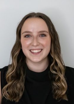 headshot of law student with long brown hair and black shirt.