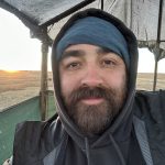 Student with hat and beard outside