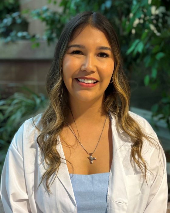Portrait of Mallory Thomas wearing a white coat. 