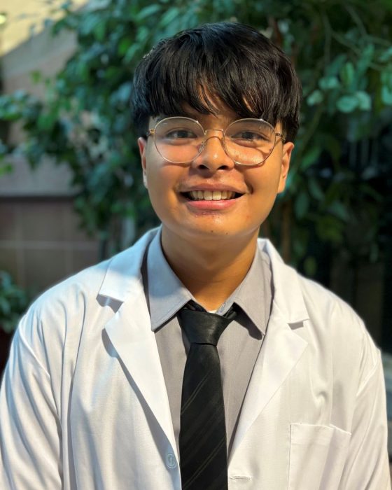 Portrait of Raphael Cristobal wearing a white coat. 