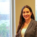 Dr. Amani Hamad standing by a window.