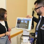A student and professor look at a computer screen showing electrical impedance tomography.