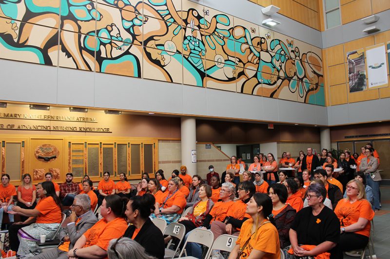 – A crowd of people wearing orange shirts inside the Helen Glass Centre for Nursing.