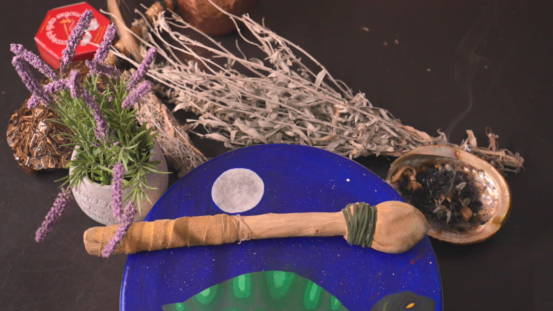 Bundle of ceremonial items including medicines, drum, and rattle