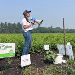 Kristen MacMillan lectures in a field