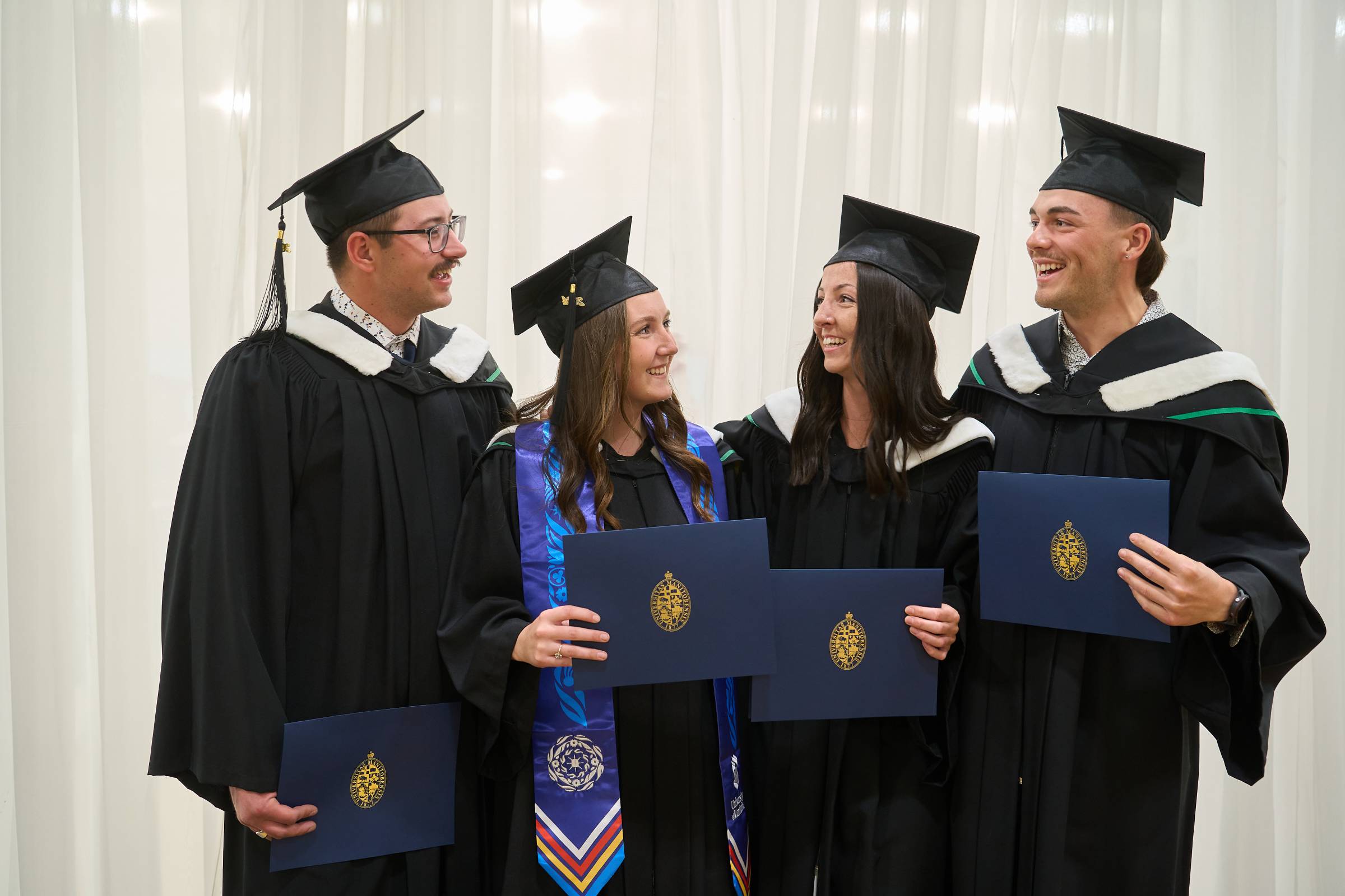 A group of graduating UM students celebrating their success.