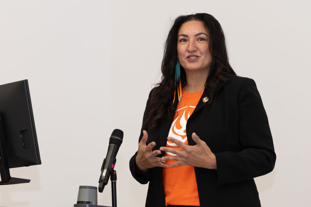 Dr. Angie Bruce speaks at a microphone.