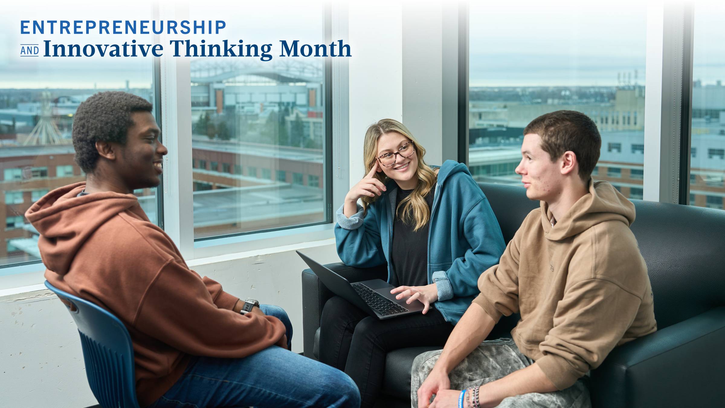 Three students smiling and having a conversation on the UM campus.