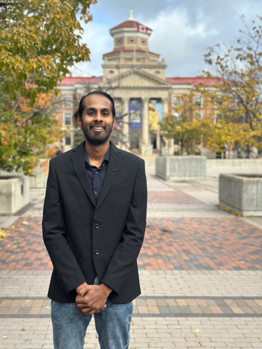 Man stands before path to UM Administration Building