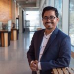 Md. Abdul Aziz smiling at the camera in a hallway at the Apotex Centre.