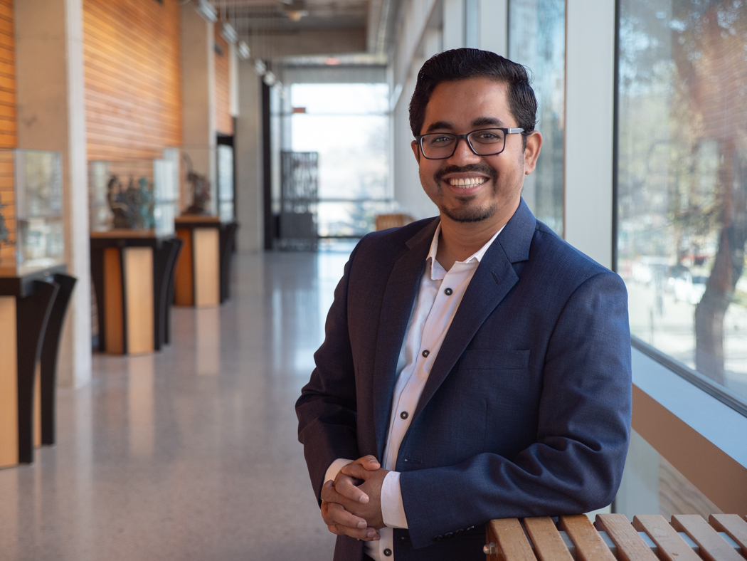 Md. Abdul Aziz smiling at the camera in a hallway at the Apotex Centre.