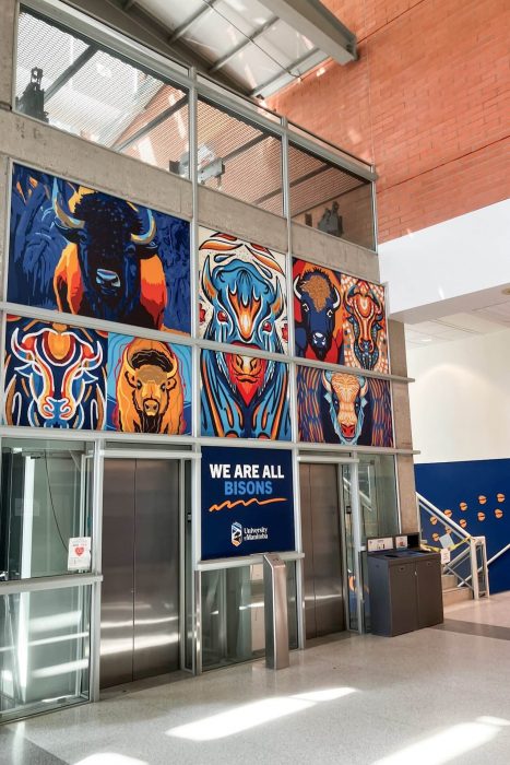 Illustrated bisons are shown applied above elevator doors.