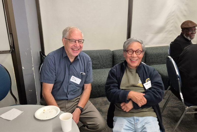 Peter Zadraka and Robert Shiu, professors emeriti, reconnect at the ESSENCE project launch event.