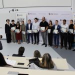 A photographer takes a photo of the dean of the Dr. Gerald Niznick College of Dentistry and 12 students. The students are each holding a certificate.