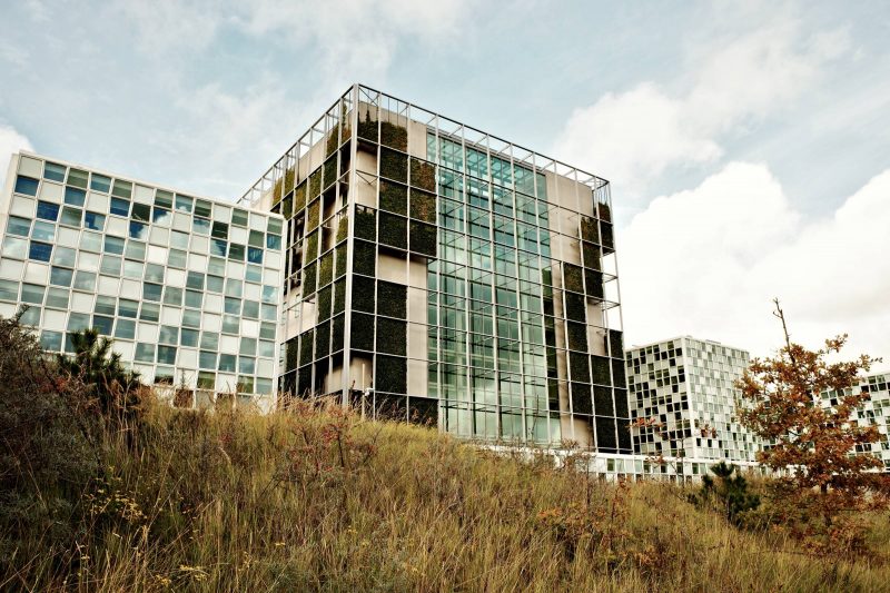 International Criminal Court building taken from bottom of hill with grassy slope visible