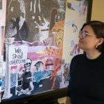 Jen Sebring looks at a digital display showing a collage of participant-created artwork.