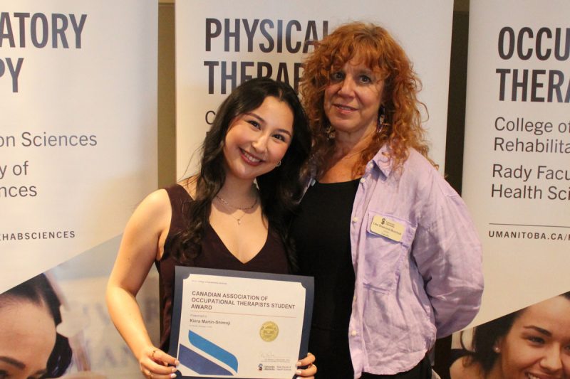 Kiera Martin-Shimoji poses with an award with Lisa Diamond-Burchuk.
