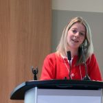 Dr. Jennifer Rabin speaks at a lectern.