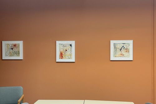 3 pieces of framed art made with thread and fabric on a wall