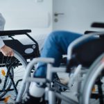 Close-up of young women at wheelchairs in a hospital.