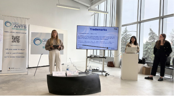 Three law students from the Manitoba Legal Clinic for the Arts give a presentation to Master of Fine Arts students at the University of Manitoba.