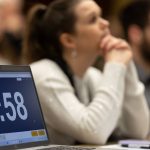 3MT timer with blurred audience members