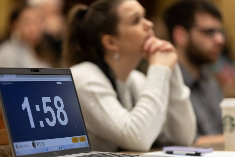 3MT timer with blurred audience members